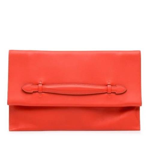 Pre-owned Leather clutches Hermès Vintage , Orange , Dames