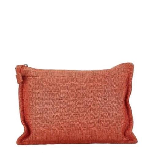 Pre-owned Canvas clutches Hermès Vintage , Orange , Dames