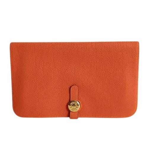 Pre-owned Leather clutches Hermès Vintage , Orange , Dames