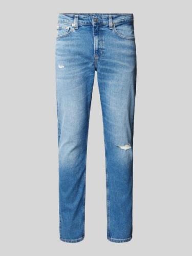 Slim tapered fit jeans in destroyed-look